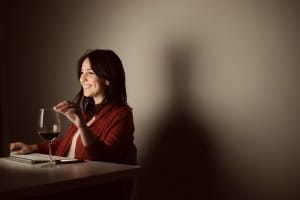 Woman in video call with a glass of wine on hand