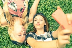 Girls taking selfies on social media