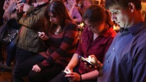 Strike Up A Chat - people staring at their mobile phones