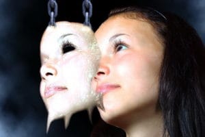 Projecting Rejection - girl hiding behind a mask